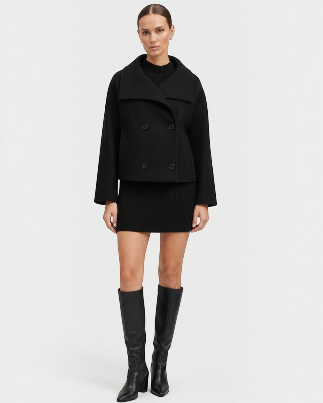 Luna Moda Francisca black cropped double-breasted coat with wide lapels worn over a matching ribbed mini dress