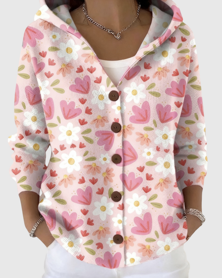 Luna Moda Gaia hooded cardigan in soft pink with a floral and heart pattern, featuring brown buttons and long sleeves.