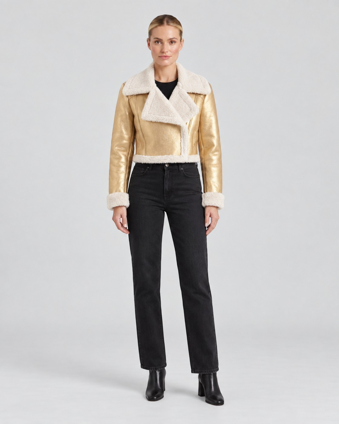 Luna Moda Mariella gold metallic cropped jacket with white fleece lining worn by a model with black jeans
