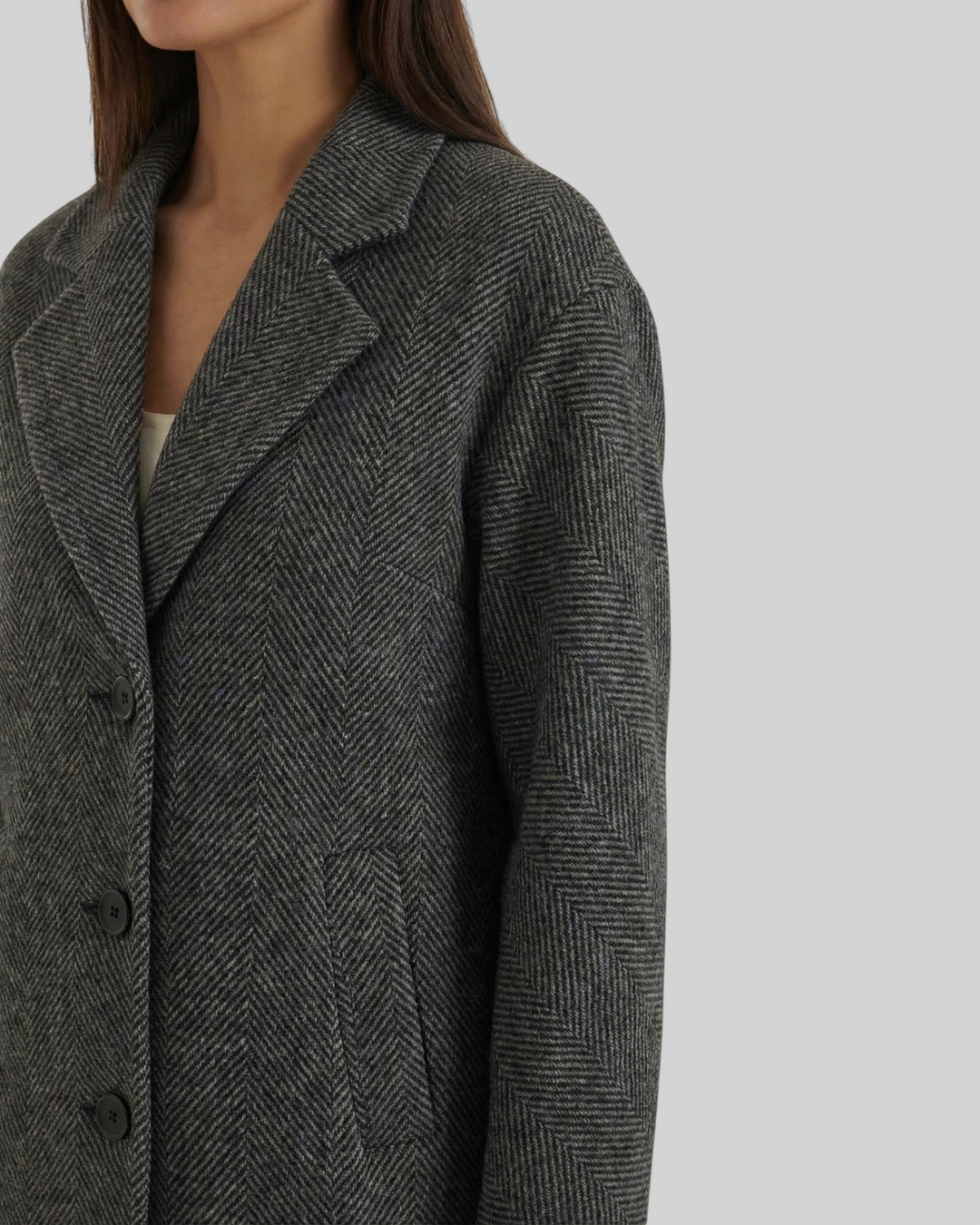 Luna Moda ANNALENA long grey herringbone coat with notched lapels and button closure worn by a woman