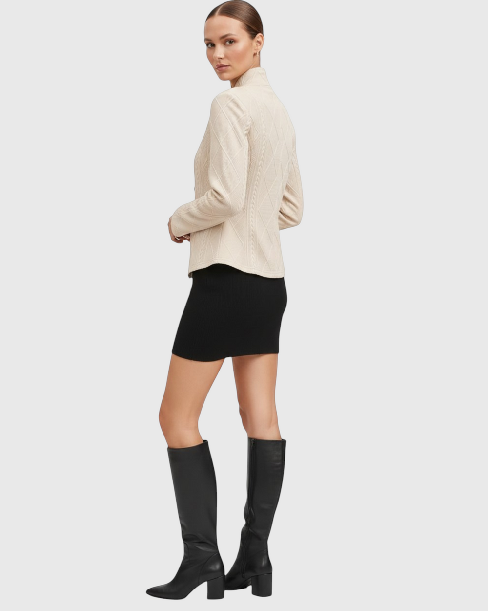 Luna Moda GRAZIA beige mid-season coat with cable knit texture worn by a model with a black skirt and tall boots.