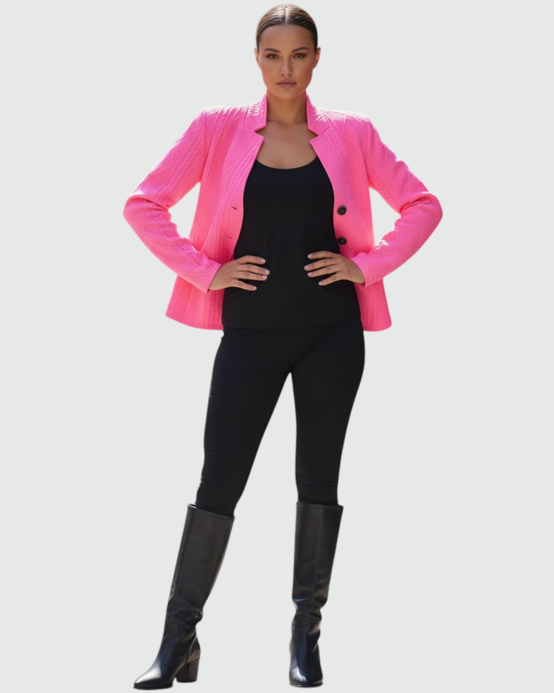 Luna Moda Grazia bright pink textured mid-season coat worn by a woman with black top, leggings, and knee-high boots.