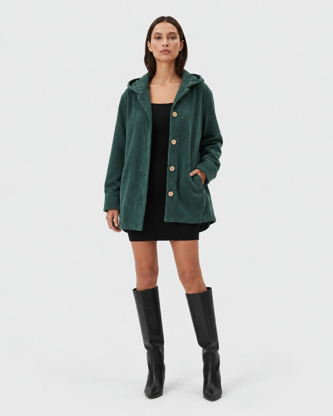 Luna Moda dark green corduroy hooded jacket with button closure worn by a model with a black dress and boots