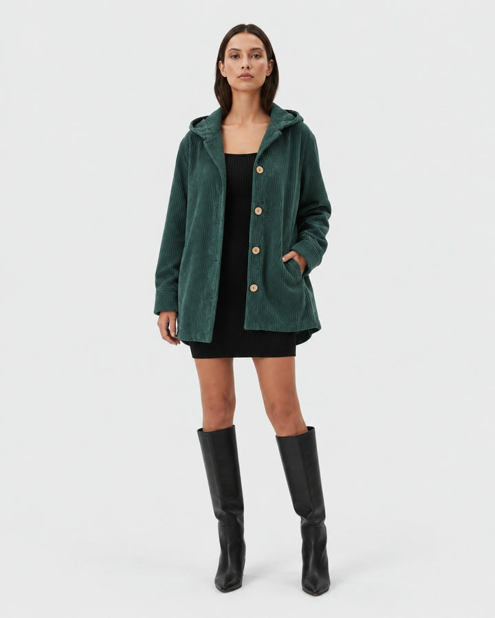 Luna Moda dark green corduroy hooded jacket with button closure worn by a model with a black dress and boots