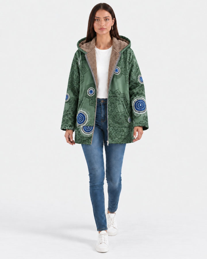 Luna Moda green hooded jacket with geometric patterns and soft sherpa lining worn by a woman with blue jeans