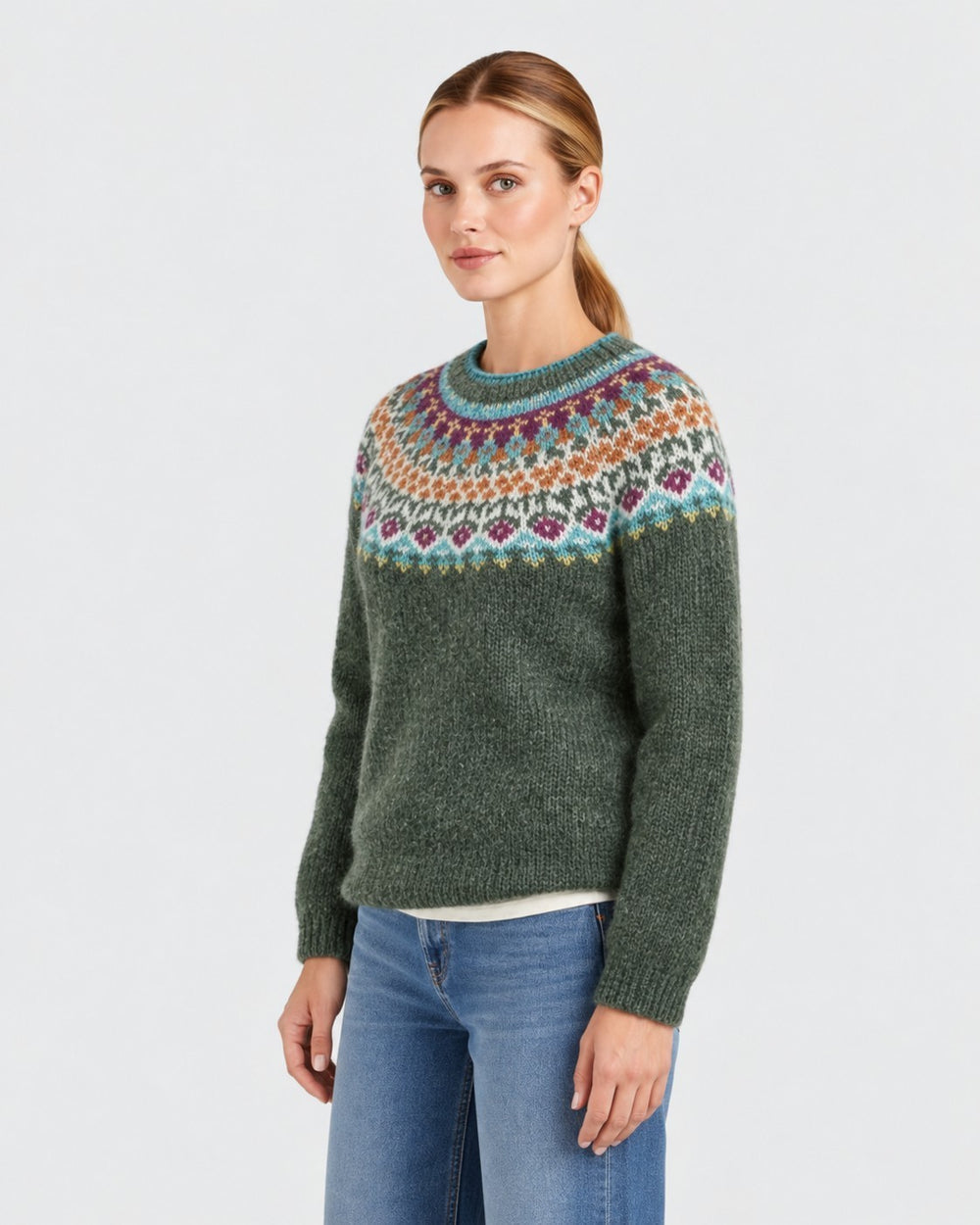Luna Moda handmade green crewneck sweater with a colorful Icelandic-style patterned yoke on a female model