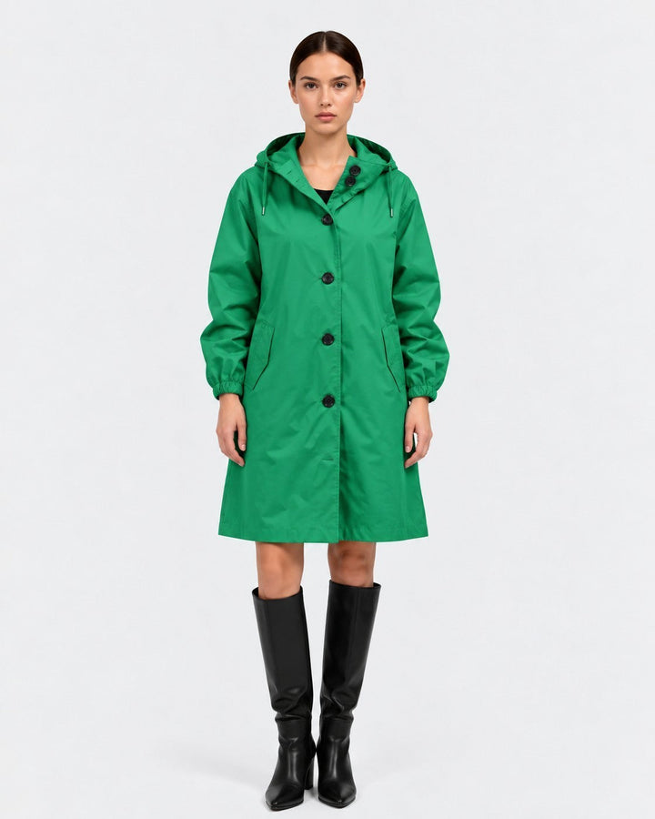 Luna Moda green oversized waterproof raincoat with hood and pockets worn by a model with black boots