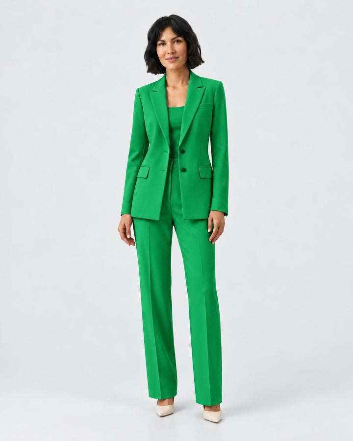 Model wearing a Luna Moda vibrant green structured blazer and matching tailored trousers for a sophisticated look.