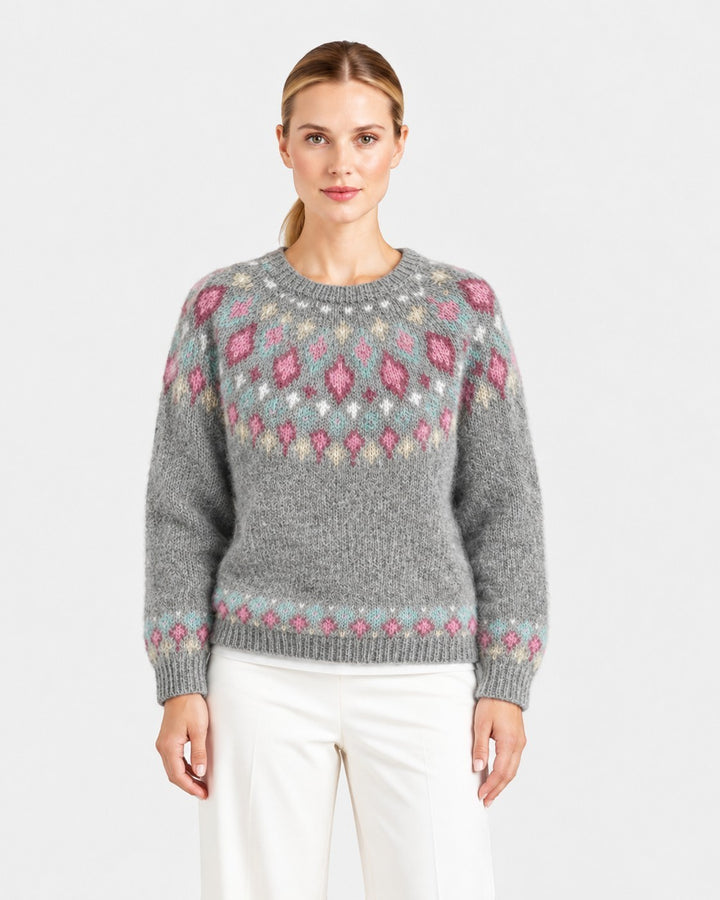Luna Moda handmade grey Icelandic sweater with a decorative pink and white diamond pattern yoke on a female model