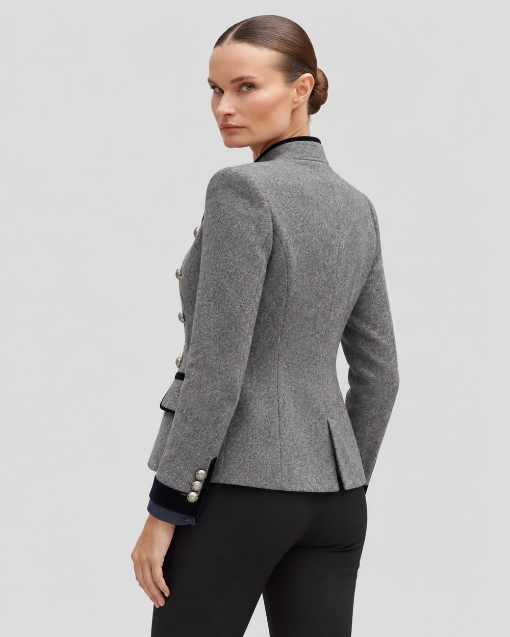Luna Moda grey short wool coat with military-style buttons and velvet trim details worn by a model, back view.