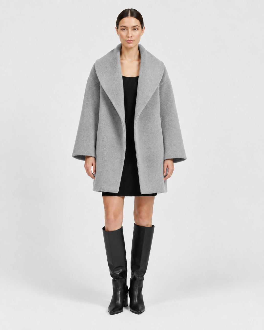 Luna Moda grey tailored windbreaker jacket with wide lapels worn by a model over a black dress and knee-high boots
