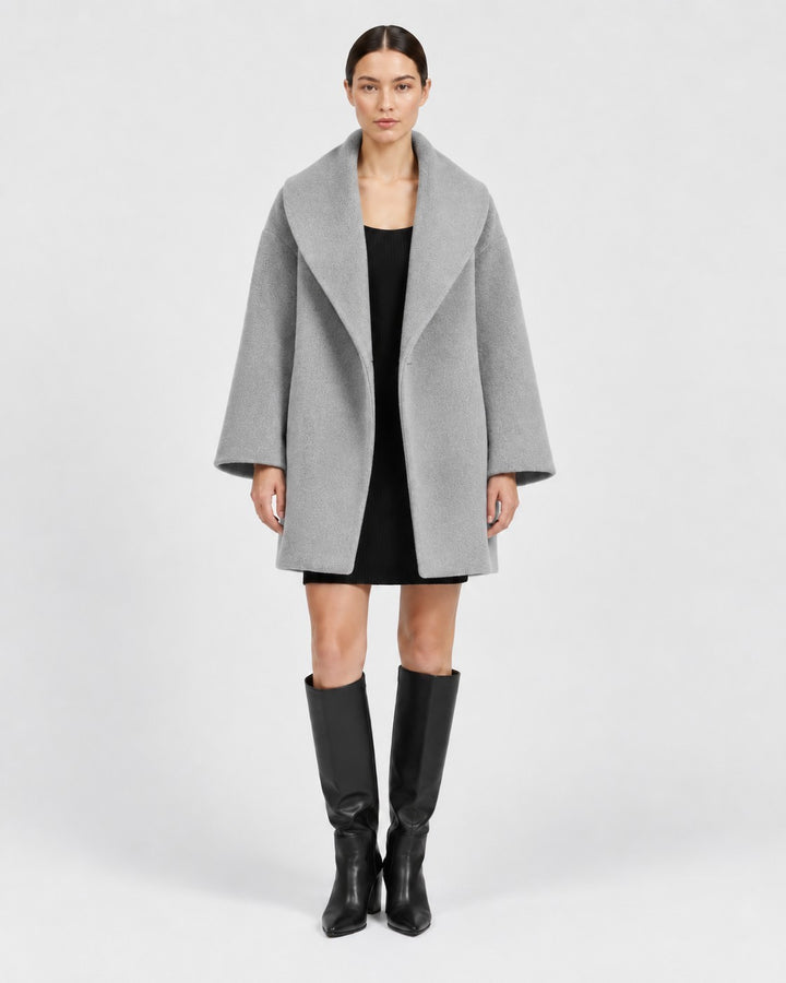 Luna Moda grey tailored windbreaker jacket with wide lapels worn by a model over a black dress and knee-high boots