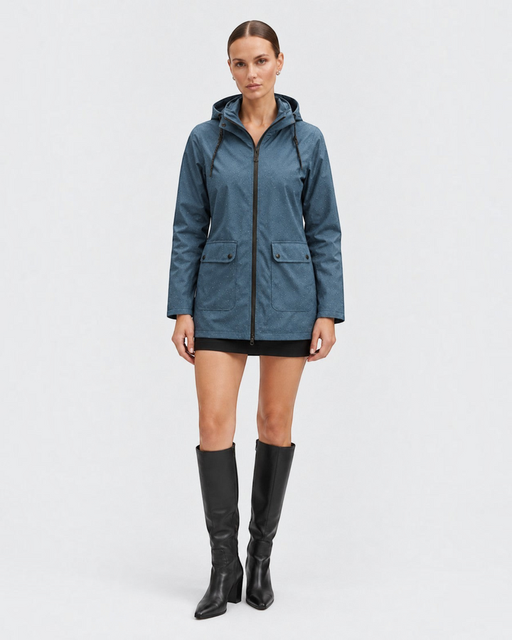 Luna Moda Iolanda blue waterproof hooded jacket with subtle dot pattern, worn by a model with black boots.