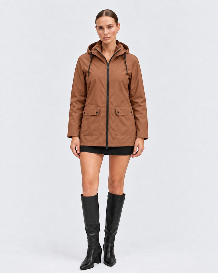 Luna Moda IOLANDA brown waterproof breathable hooded jacket worn by a model with a black skirt and knee-high boots.