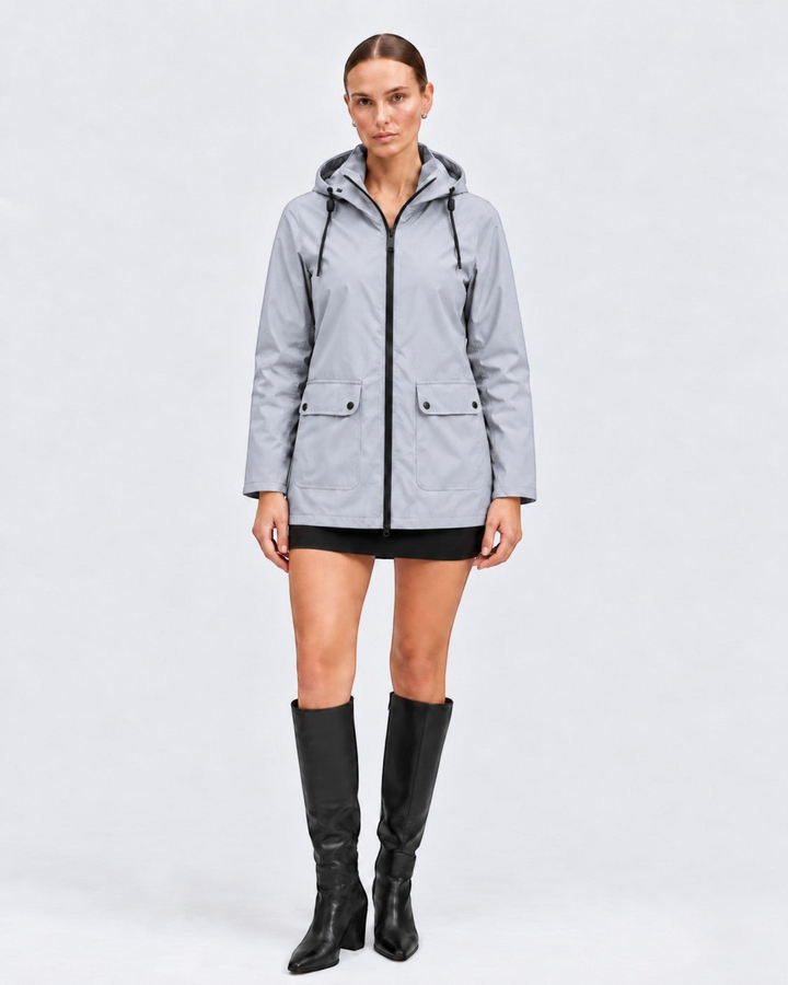Luna Moda IOLANDA grey waterproof hooded jacket with black zipper and pockets worn by a model with black boots