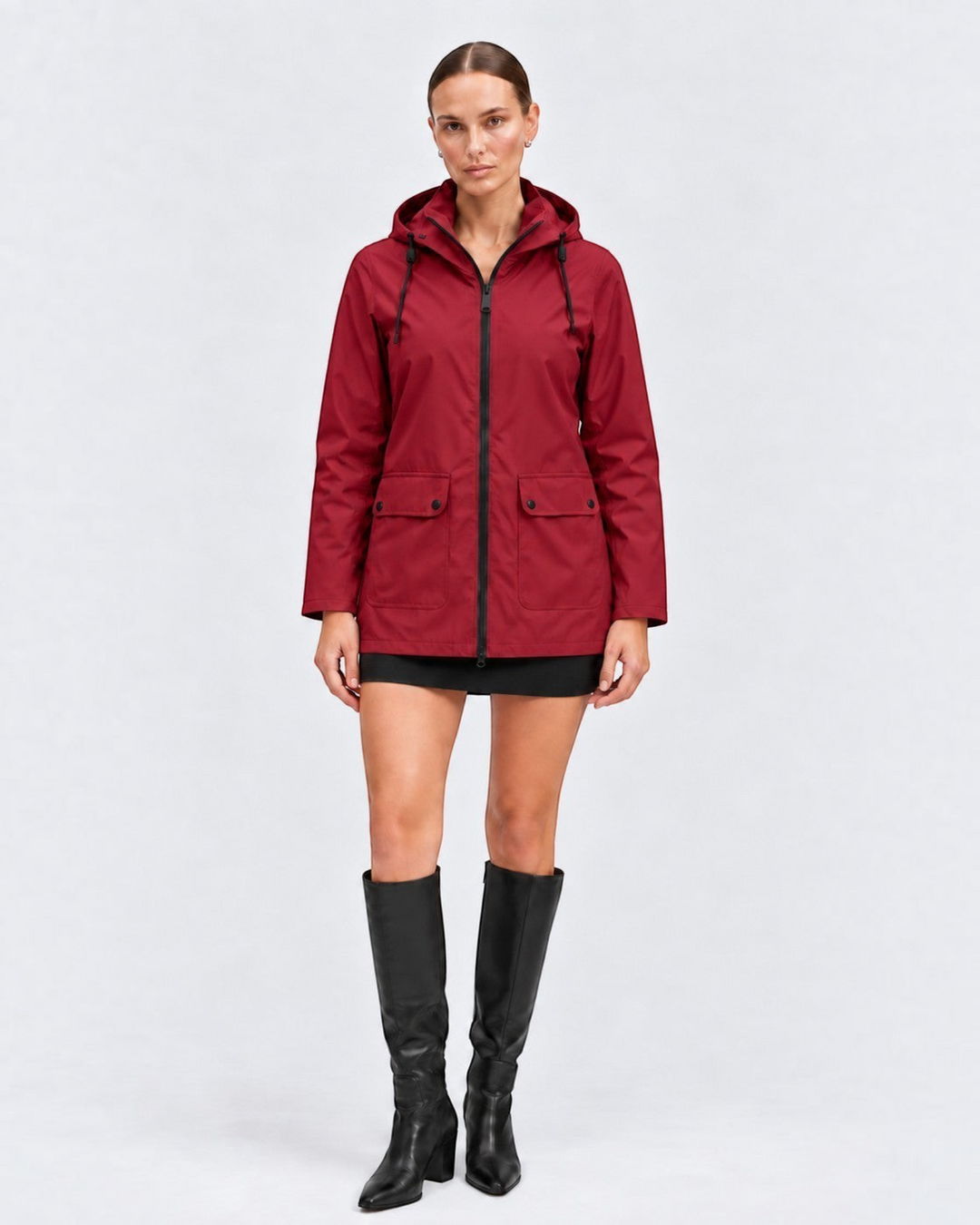 Luna Moda IOLANDA red waterproof breathable jacket with hood worn by a model with black skirt and boots