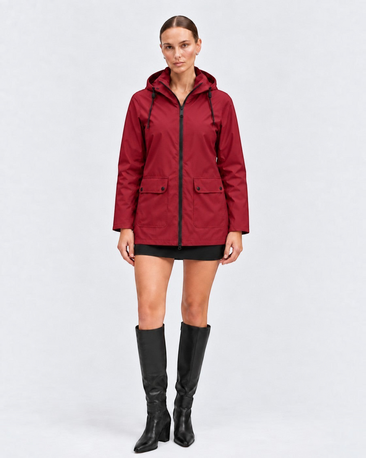 Luna Moda IOLANDA red waterproof breathable jacket with hood worn by a model with black skirt and boots