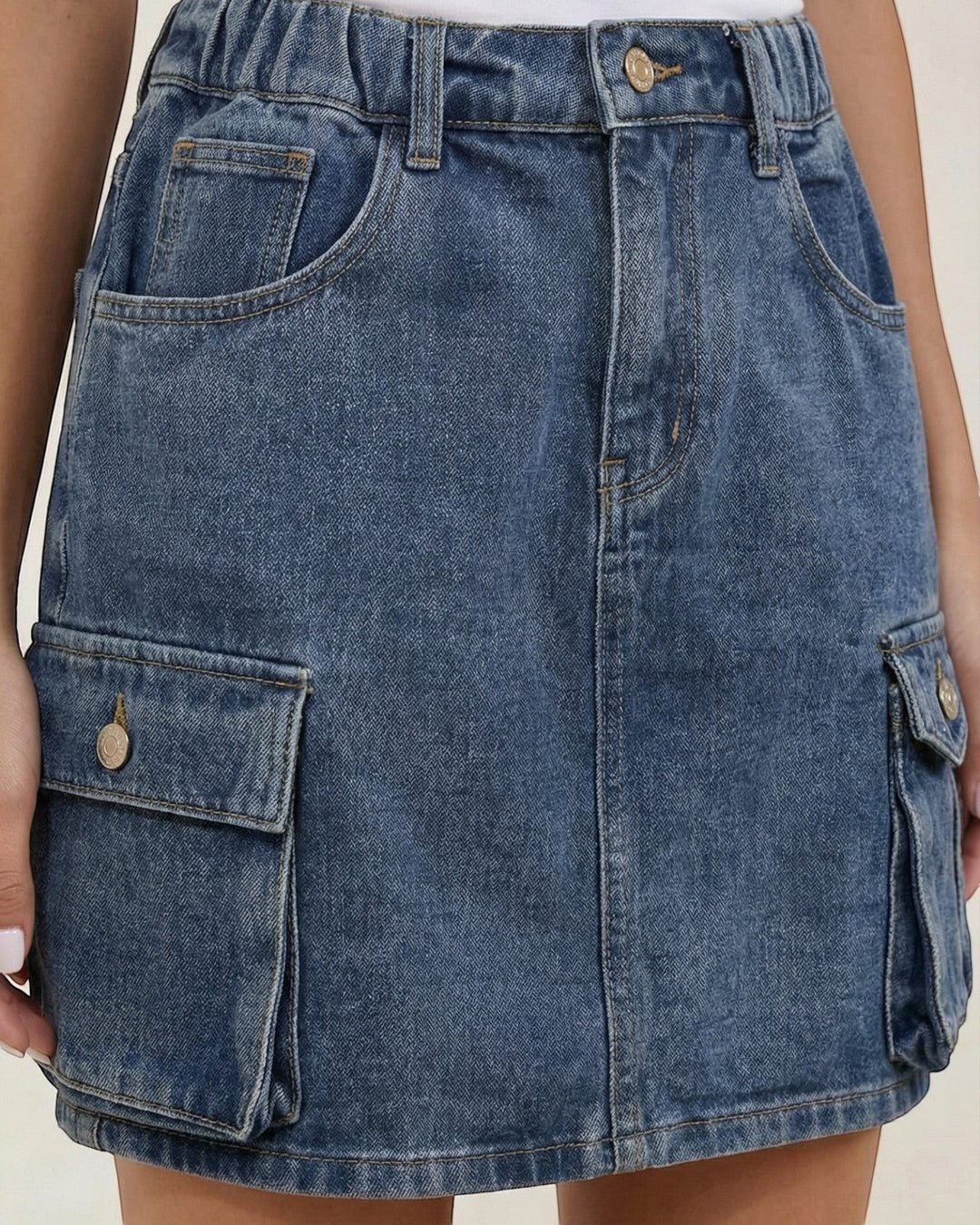 Luna Moda blue denim cargo mini skirt with an elasticated waist, multiple side pockets, and an A-line silhouette.
