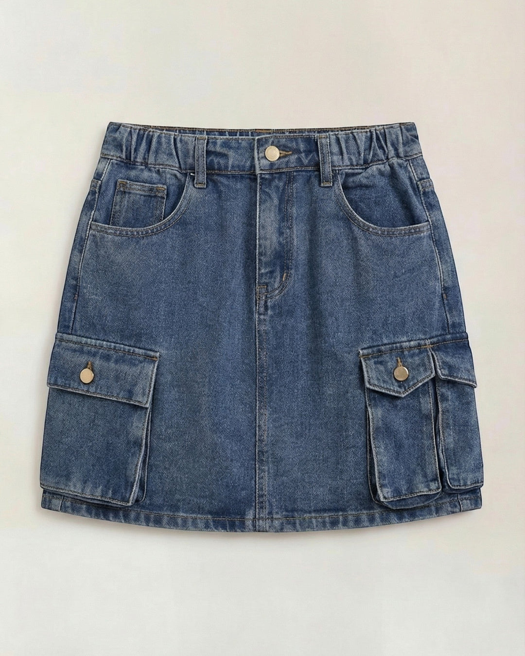 Luna Moda Ivy denim cargo mini skirt with an elastic waistband and functional side pockets in a medium blue wash.