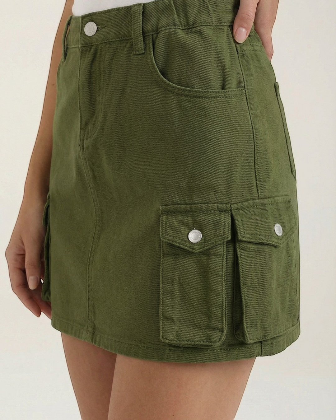 Luna Moda olive green A-line cargo mini skirt with functional side pockets and elasticated waist on a model