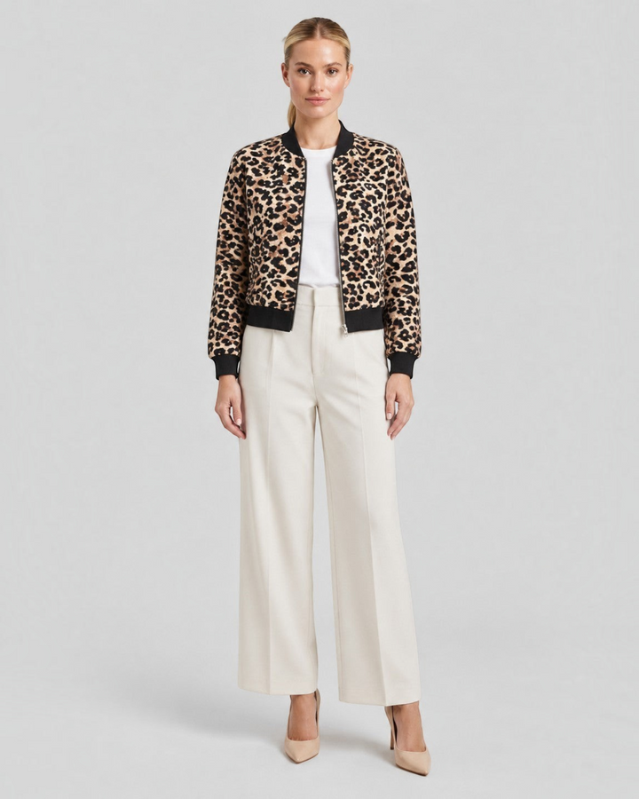 Luna Moda leopard print bomber jacket with black ribbed cuffs worn by a model with white trousers and heels