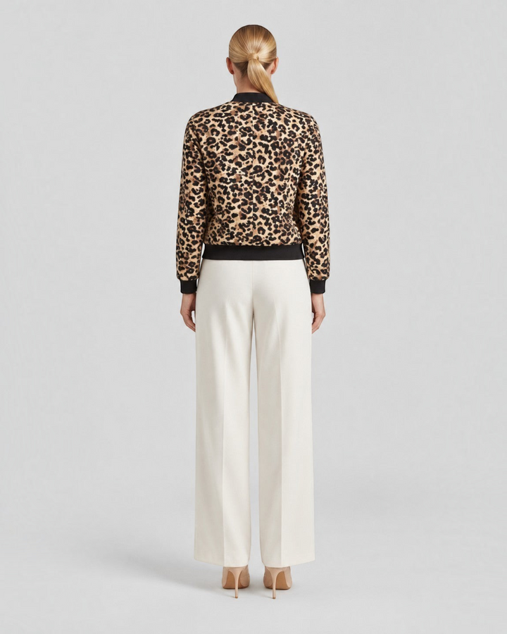 Luna Moda leopard print bomber jacket with ribbed cuffs worn by a model from the back view with cream trousers