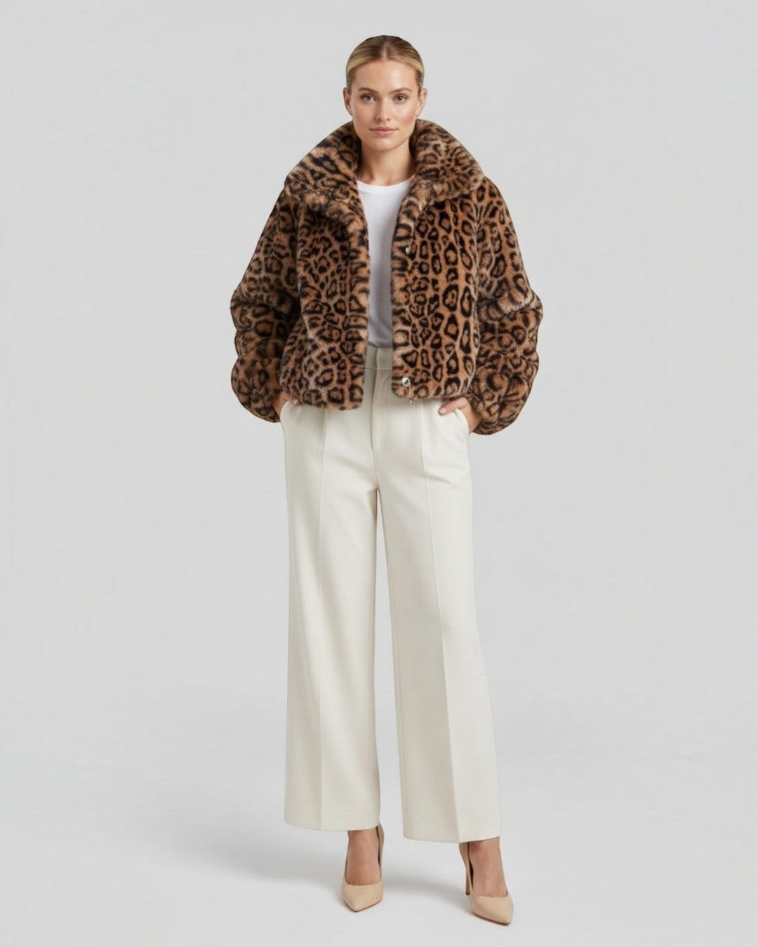Luna Moda leopard print faux fur cropped coat worn by a model with white trousers and heels against a grey background
