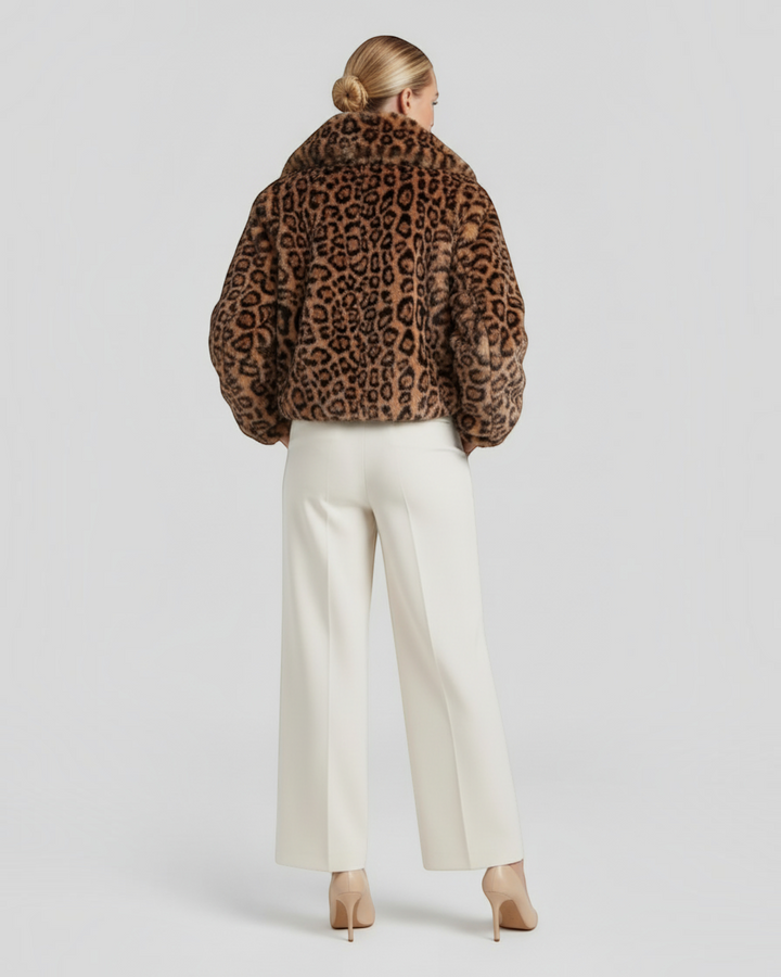 Luna Moda leopard print faux fur jacket worn by a woman with cream trousers and heels, back view