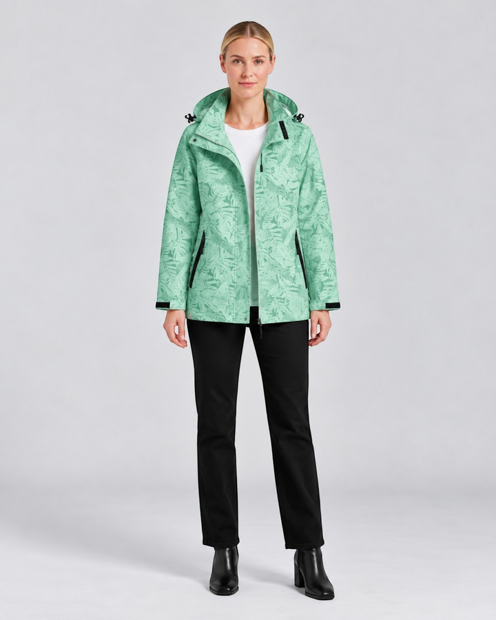 Luna Moda lightweight waterproof hooded jacket in light green with a tropical leaf print worn by a female model.