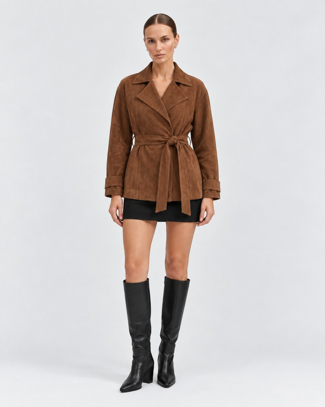 Luna Moda Lorenza brown suede wrap jacket with tie waist belt worn by a model with black skirt and knee-high boots