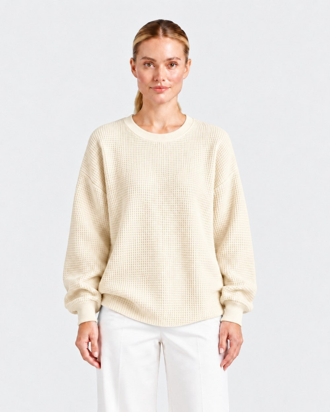 Luna Moda Lucia cream waffle knit oversized crewneck sweater worn by a model with white trousers