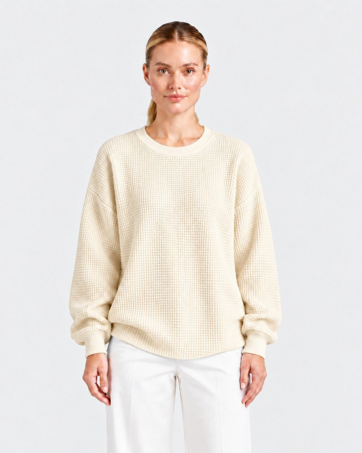 Luna Moda Lucia cream waffle knit oversized crewneck sweater worn by a model with white trousers