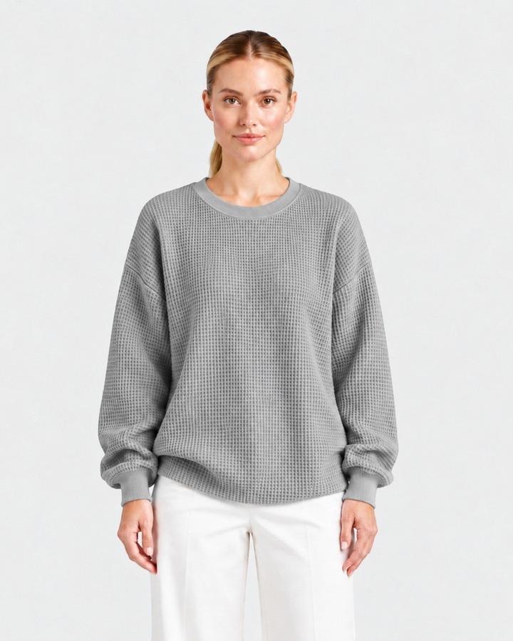 Luna Moda Lucia grey waffle knit oversized sweater with a crew neck worn by a model with white trousers