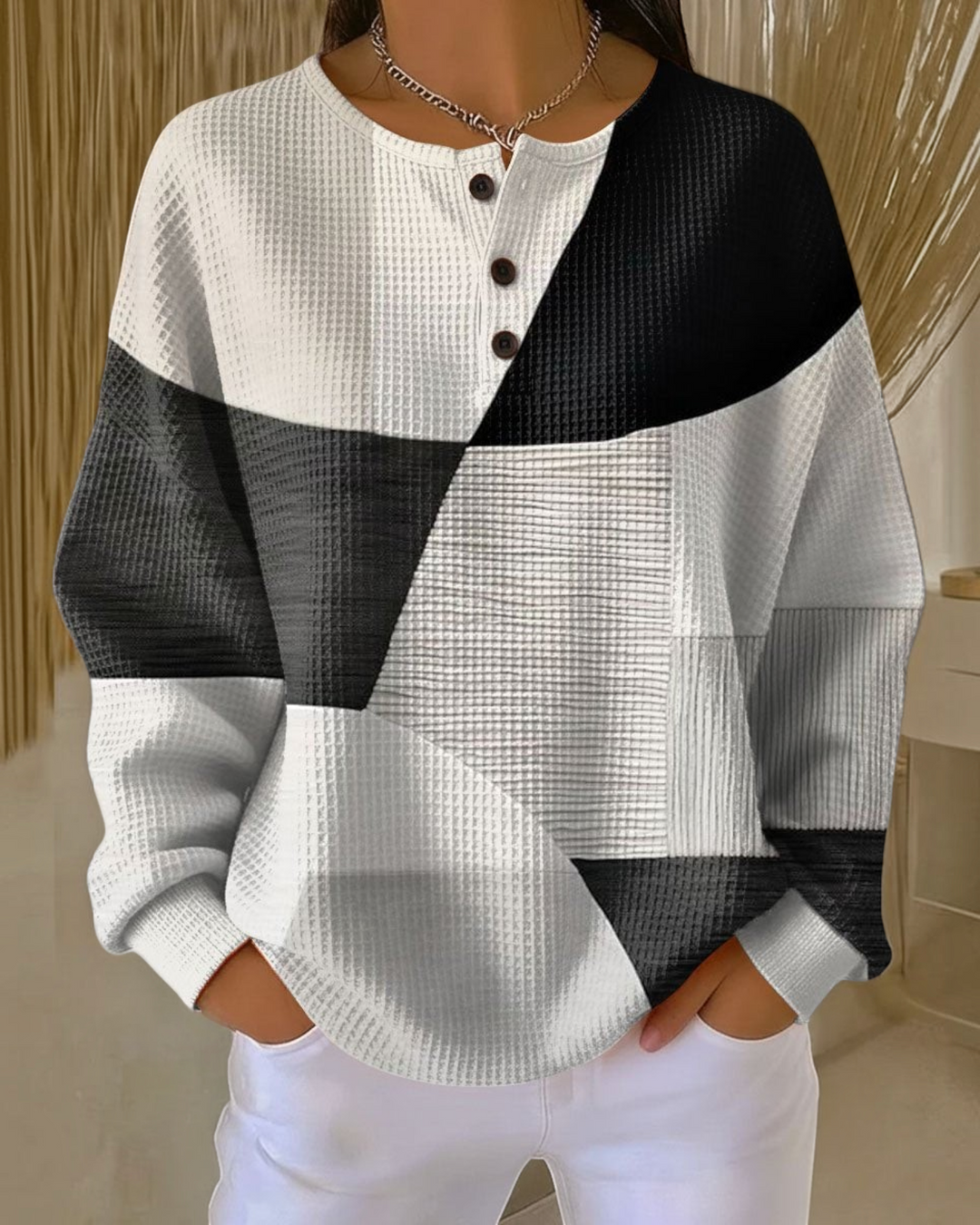 Luna Moda Marcella waffle knit Henley sweater featuring a black, white, and grey geometric color block pattern.
