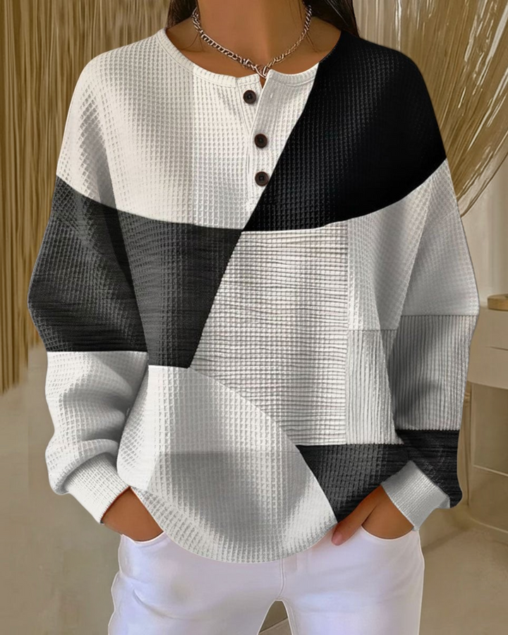 Luna Moda Marcella waffle knit Henley sweater featuring a black, white, and grey geometric color block pattern.