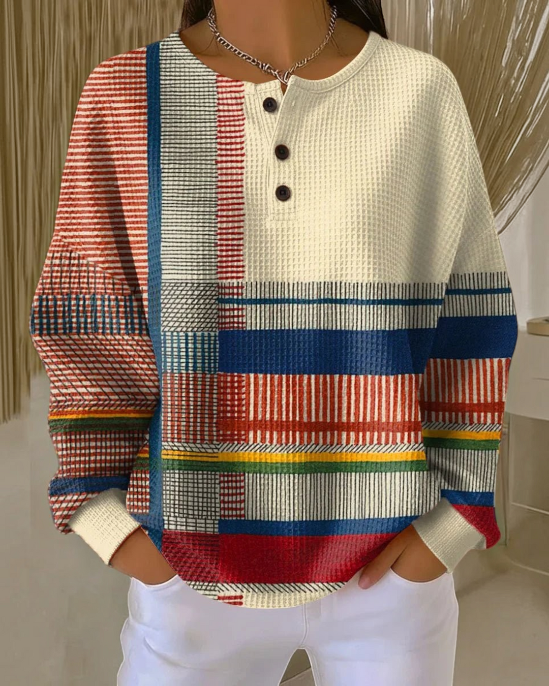Luna Moda Marcella Henley sweater in a cream waffle knit with a multi-colored geometric block pattern and buttons.
