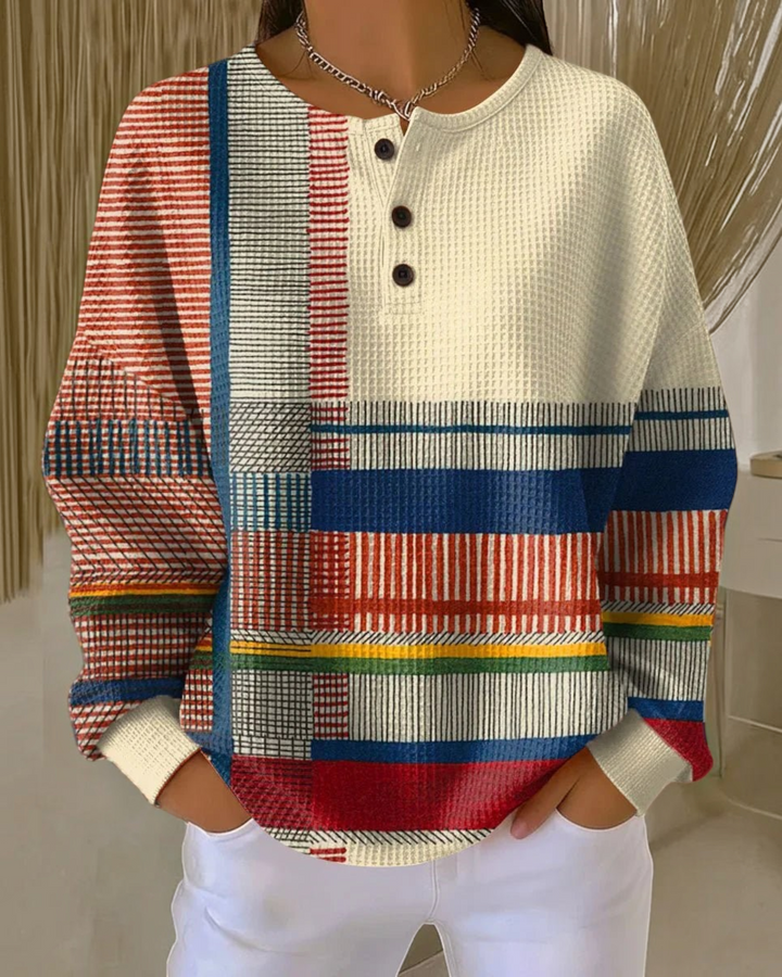 Luna Moda Marcella Henley sweater in a cream waffle knit with a multi-colored geometric block pattern and buttons.