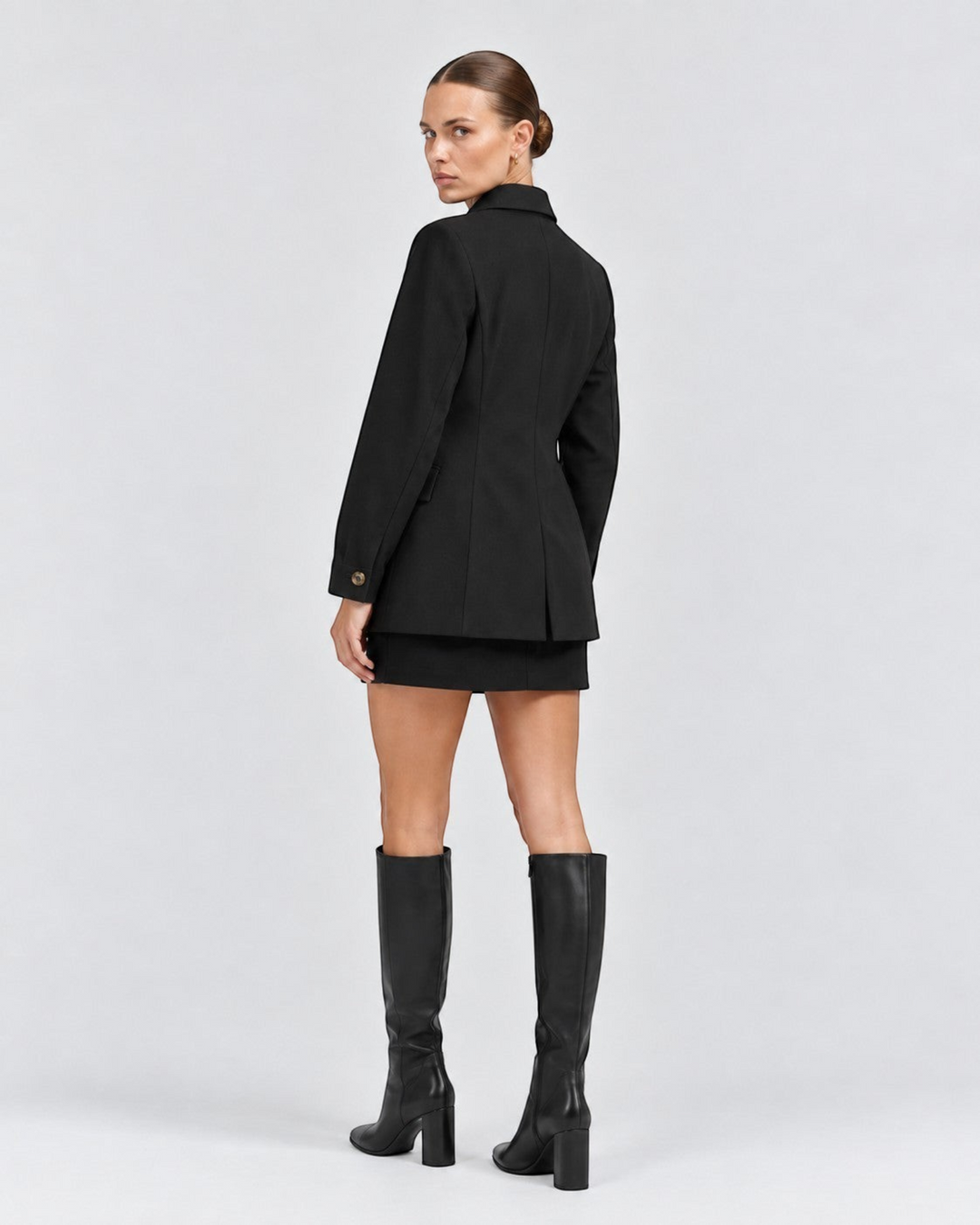Luna Moda Margarida black premium blazer worn by a model with a matching mini skirt and tall leather boots