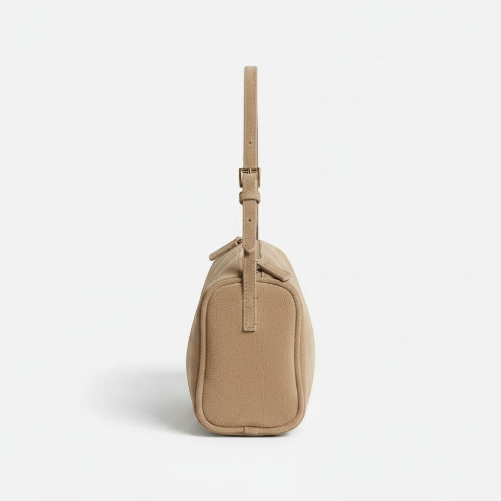 Luna Moda Marisa beige suede shoulder bag with adjustable strap, side view showing modern minimalist design.