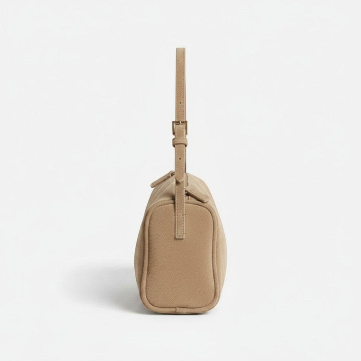 Luna Moda Marisa beige suede shoulder bag with adjustable strap, side view showing modern minimalist design.