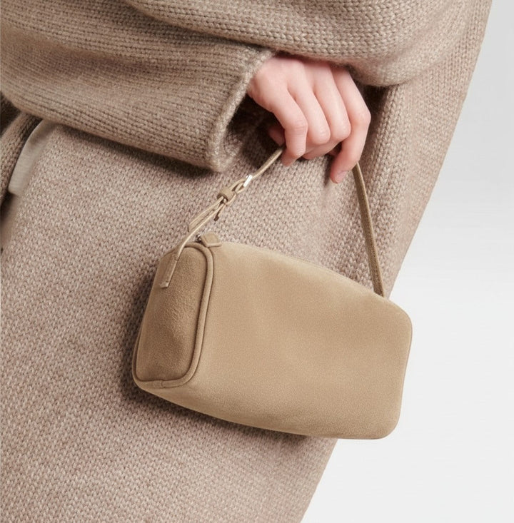 Luna Moda MARISA beige suede shoulder bag with a minimalist rectangular design held by a hand in a knit sweater