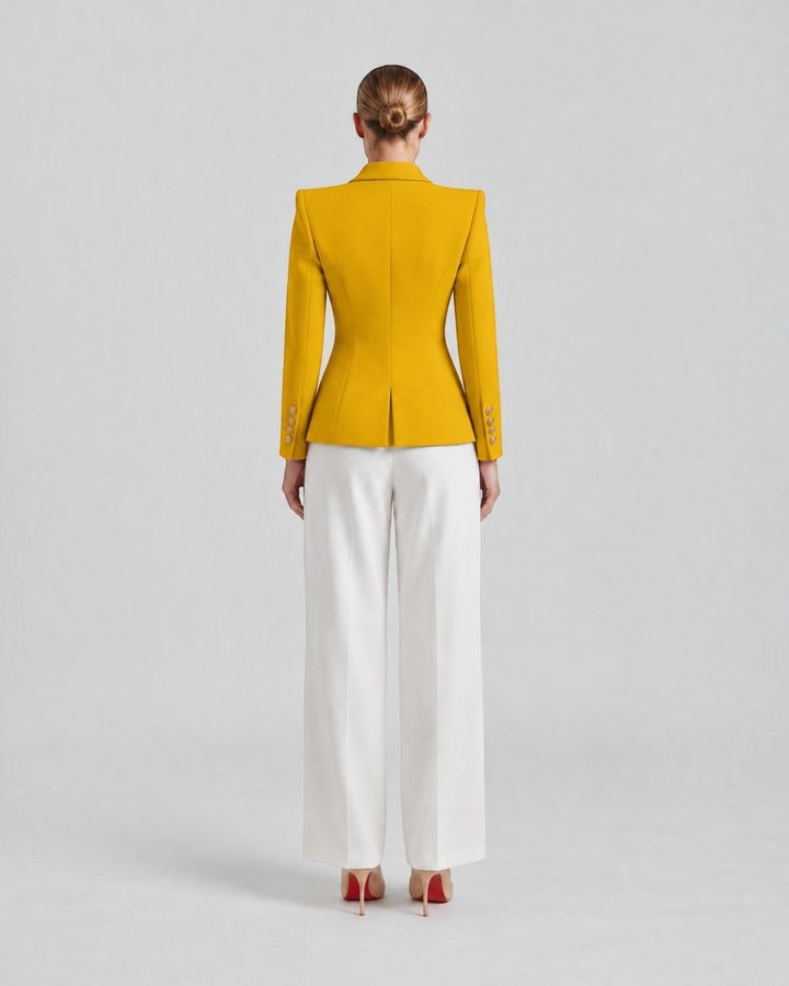 Luna Moda Paolina structured mustard yellow blazer with gold decorative buttons, worn with white trousers, back view