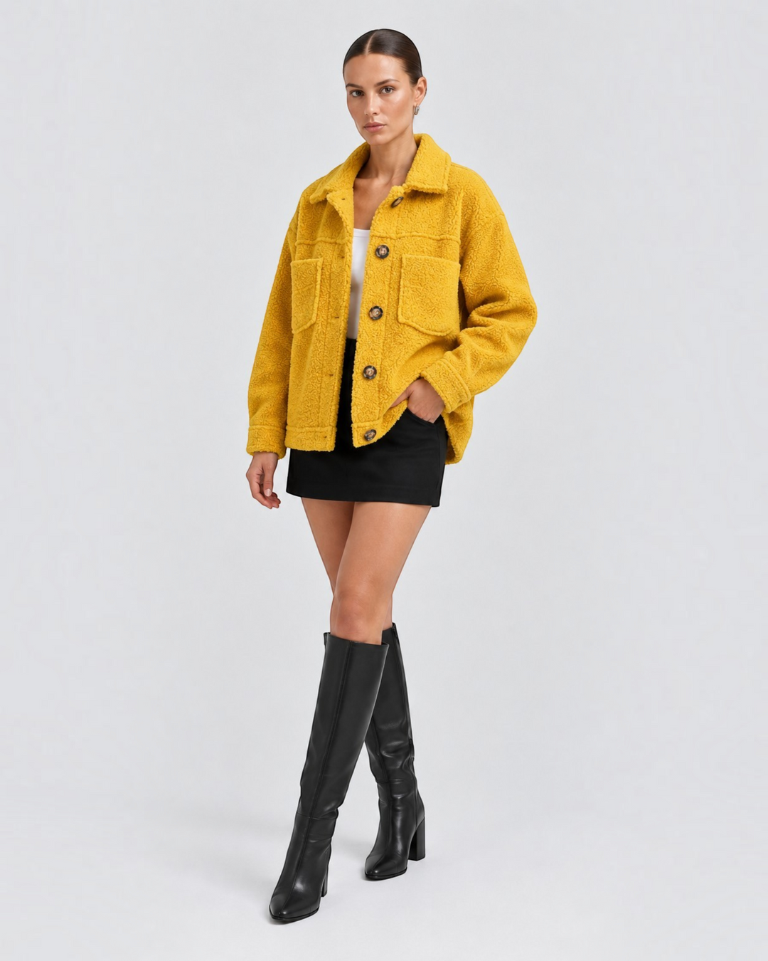 Model wearing a mustard yellow Luna Moda short fleece jacket with lapels, button front, and large pockets.