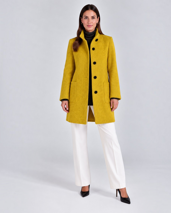 Luna Moda NELLA mustard yellow high-neck wool coat worn by a model with white trousers and black heels