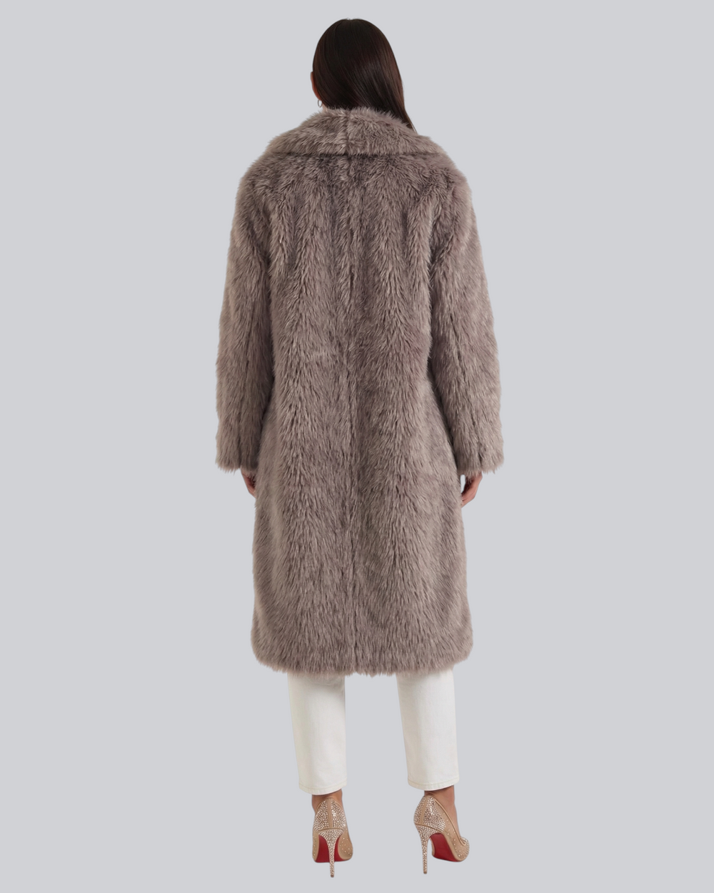 Luna Moda Narcissa long taupe faux fur coat with oversized lapels, back view on a model wearing white trousers