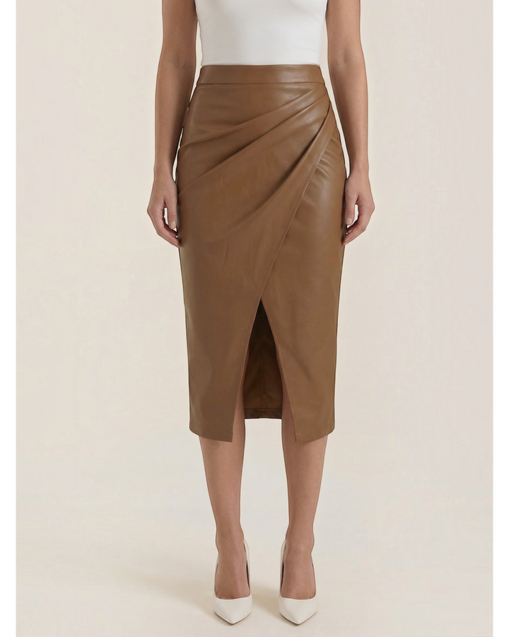 Luna Moda brown faux leather midi skirt featuring a draped design and a front slit, worn with a white top.
