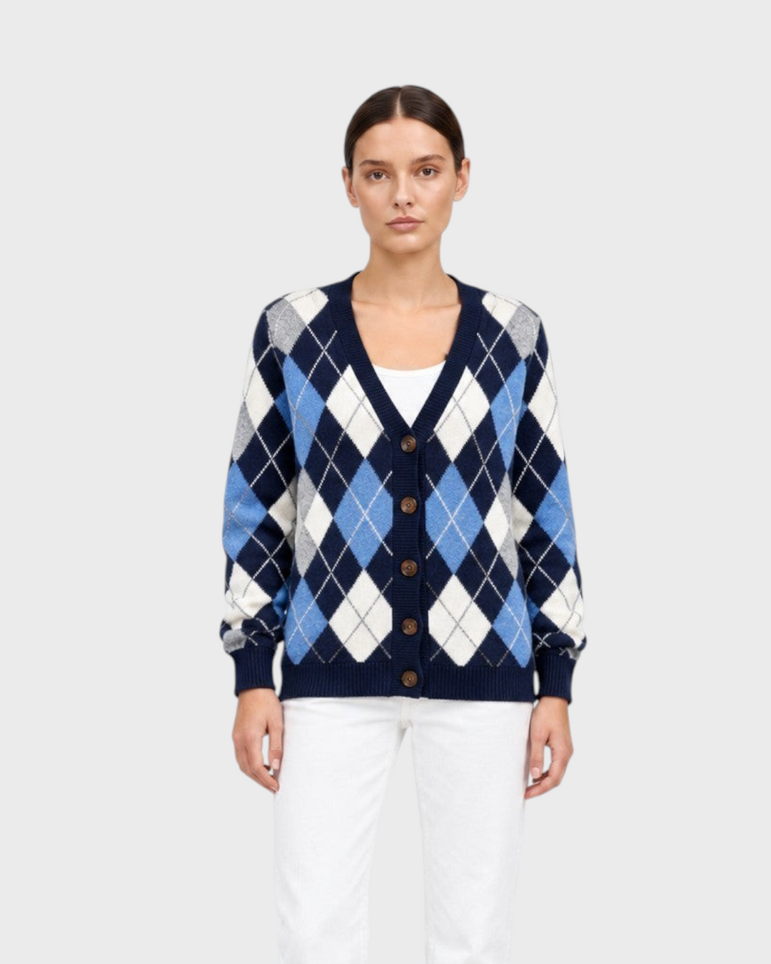 Luna Moda navy blue argyle cardigan with button front, worn by a model with white trousers and black boots