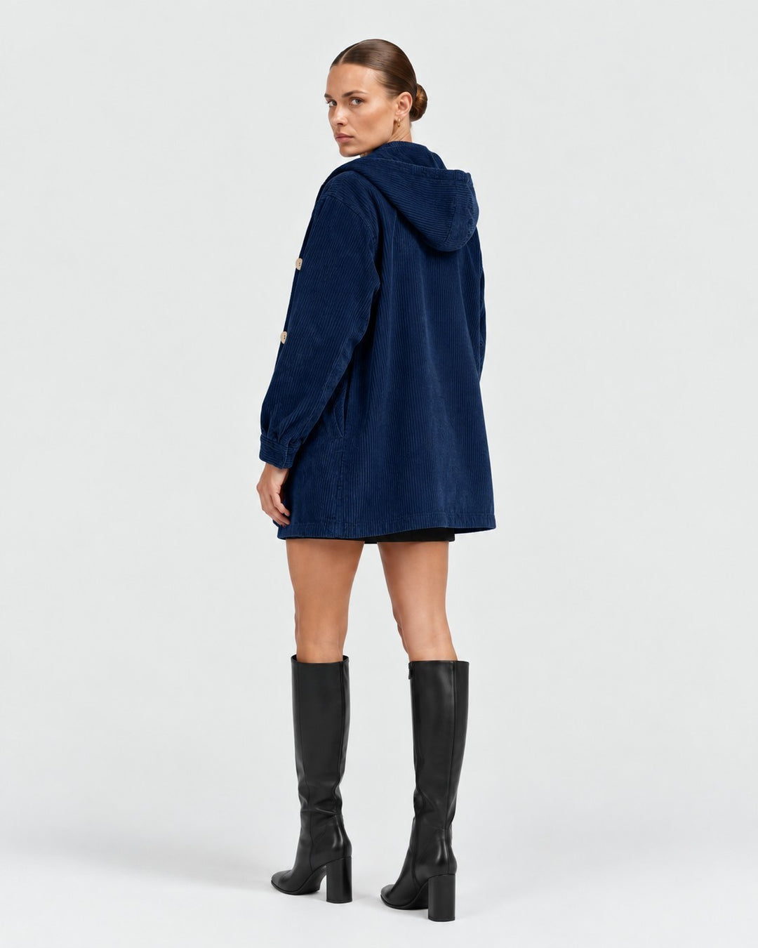 Luna Moda navy blue corduroy hooded jacket with button closure worn by a model with black knee-high boots
