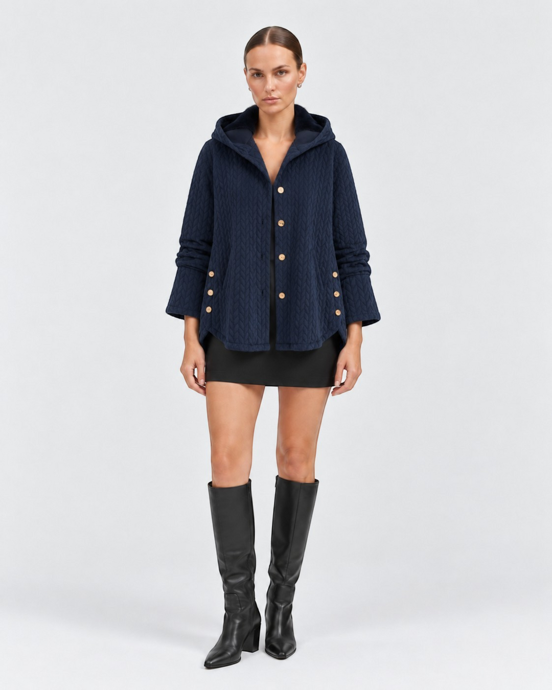 Luna Moda navy quilted hooded jacket with decorative side buttons worn by a model in a studio setting
