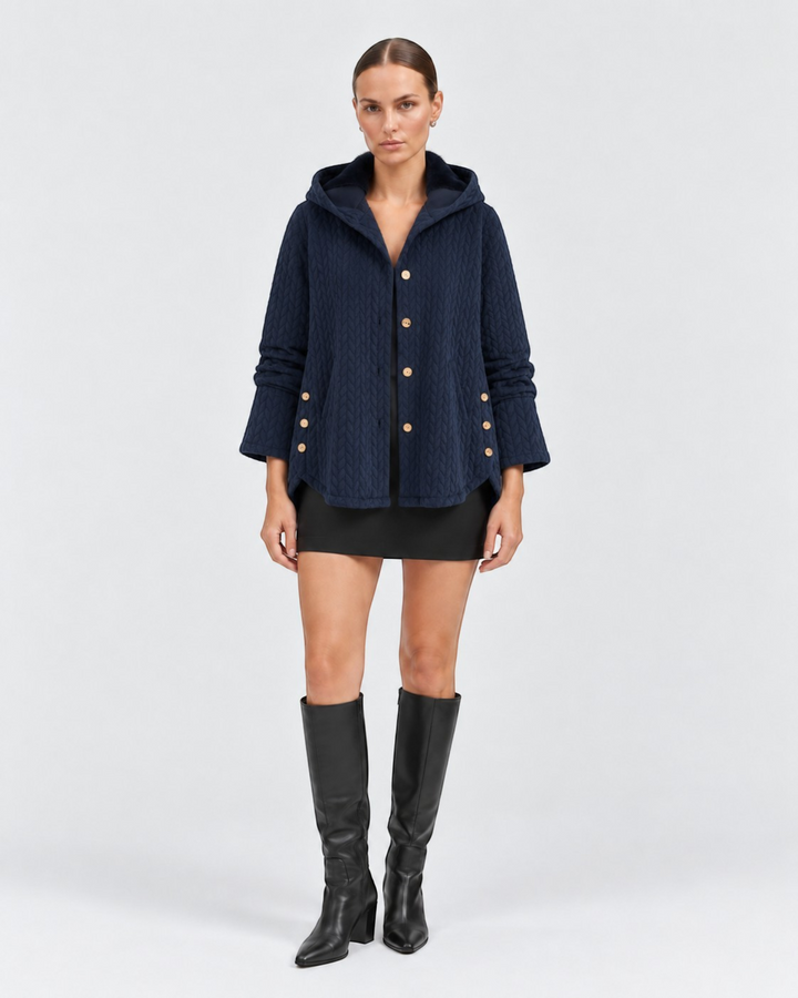 Luna Moda navy quilted hooded jacket with decorative side buttons worn by a model in a studio setting